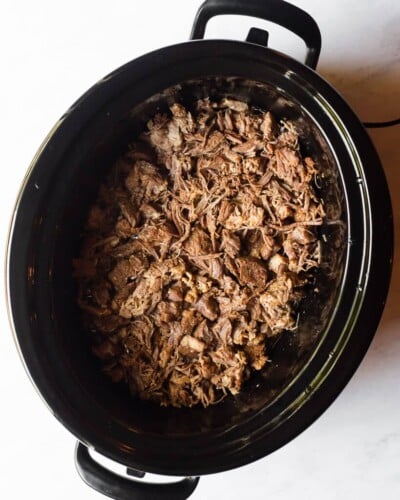 a cooked freezer meal in a slow cooker sitting on a marble surface